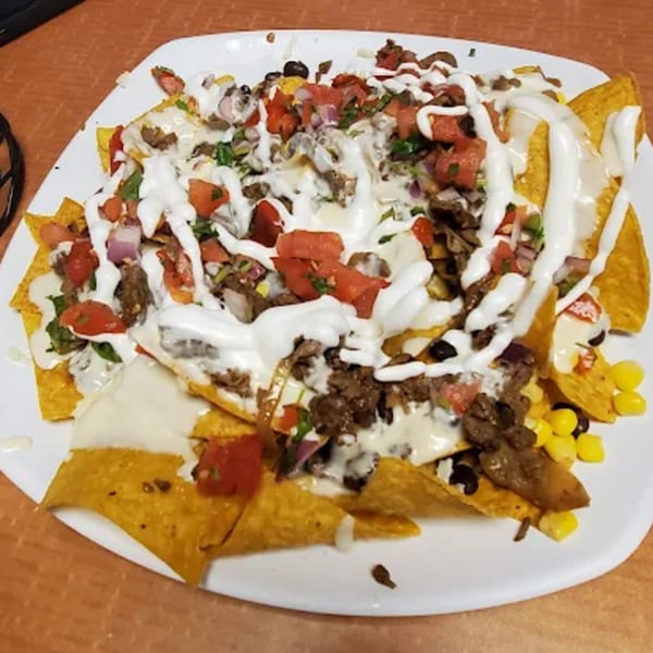 Mi Rinconcito's nachos with beef, pico de gallo, corn, black beans, and sour cream.